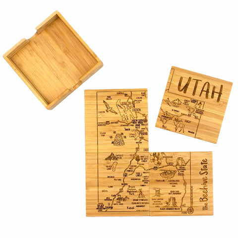 Introducing the 4-Piece Utah Puzzle Coaster Set with Case by Totally Bamboo, a remarkable set featuring laser-engraved coasters that display a map of Utah with city names and landmarks. These coasters fit together to create the map, with one prominently labeled "UTAH." A wooden case is included to elegantly store this extraordinary set.