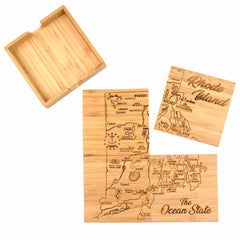 The 4-Piece Rhode Island Puzzle Coaster Set with Case by Totally Bamboo features a distinctive design with laser-engraved maps of Rhode Island labeled "The Ocean State." One coaster is partially removed, and the set includes a matching bamboo holder.