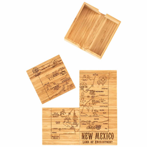 The 4-Piece New Mexico Puzzle Coaster Set with Case from Totally Bamboo boasts laser-engraved bamboo coasters adorned with a map of New Mexico featuring its cities and landmarks. The set includes four coasters and comes in a wooden box with an open lid, with one coaster proudly stating "New Mexico: Land of Enchantment.