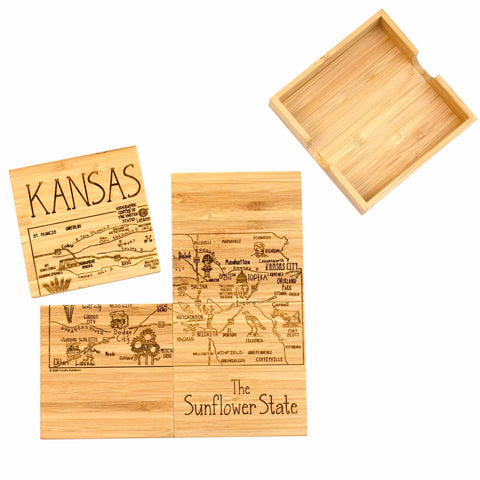 The 4-Piece Kansas Puzzle Coaster Set with Case by Totally Bamboo features laser-engraved artwork of Kansas maps and notable cities on bamboo coasters. The coasters are decorated with landmarks, rivers, and are labeled "KANSAS" and "The Sunflower State." An empty wooden holder accompanies these distinctive coasters.