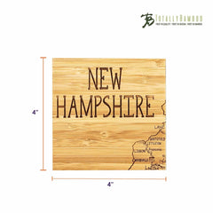 This distinctive gift includes a 4-inch by 4-inch laser-engraved bamboo coaster highlighting towns such as Lisbon and Franconia with the words "New Hampshire" prominently displayed. It is a part of the 4-Piece New Hampshire Puzzle Coaster Set with Case from Totally Bamboo, showcasing a partial map outline on its surface.