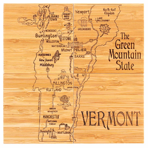 The 4-Piece Vermont Puzzle Coaster Set with Case by Totally Bamboo boasts a beautiful rustic design, showcasing a wooden map of Vermont labeled "The Green Mountain State." It highlights towns and landmarks such as Burlington, Montpelier, and Brattleboro, along with charming laser-engraved illustrations of mountains and lakes.