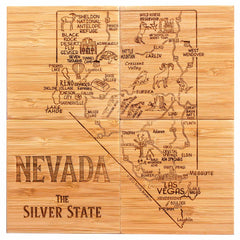 The 4-Piece Nevada Puzzle Coaster Set with Case from Totally Bamboo features a wooden map of Nevada, labeled "The Silver State." It doubles as a decorative coaster set showcasing cities, landmarks, and wildlife. Each laser-engraved coaster displays illustrations of horses, mountains, and cacti. Major cities such as Las Vegas and Reno are clearly marked, along with natural features like Lake Tahoe.