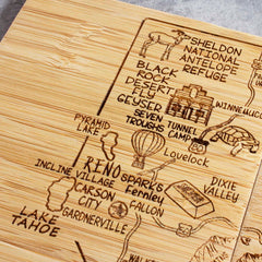 Discover the allure of Nevada with the Totally Bamboo 4-Piece Nevada Puzzle Coaster Set with Case. Each wooden coaster highlights a map design featuring laser-engraved illustrations and labels of iconic landmarks such as Reno, Lake Tahoe, and Black Rock Desert, complemented by charming icons like a hot air balloon and turtle.