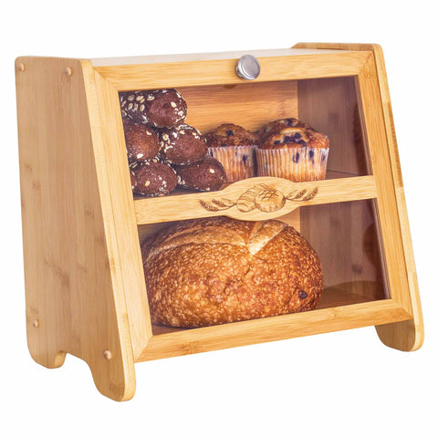 The Farmhouse Bread Box by Totally Bamboo features a transparent front panel that beautifully displays an array of baked goods, with muffins arranged on the top shelf and a round loaf on the bottom, embodying a simple and rustic farmhouse design.