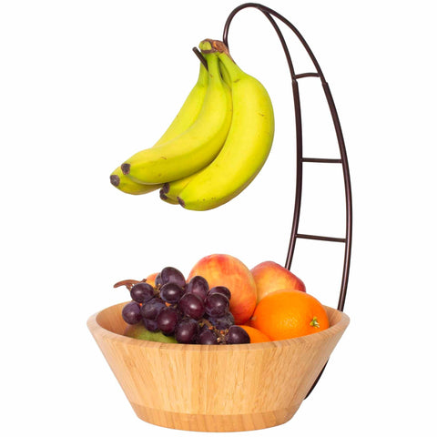 Introducing the Delightful Fruit Bowl with Banana Holder by Totally Bamboo: This charming piece features a metal banana holder that elegantly displays a bunch of bananas, while the bowl itself is filled with vibrant oranges, juicy peaches, and a cluster of red grapes.