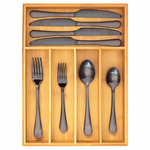 Overhead view of bamboo silverware organizer filled with flatware on white background