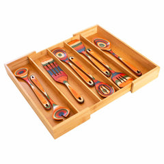 A Totally Bamboo Expandable Drawer Organizer with bamboo dividers accommodates a set of multicolored kitchen utensils, featuring spoons and spatulas. These lively utensils exhibit swirling patterns in shades of orange, red, blue, and green, bringing a vivid touch to your kitchen organization.