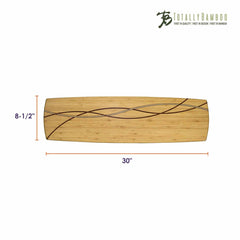 The Del Mar Extra-Large Charcuterie Board by Totally Bamboo is a rectangular serving board made from Moso bamboo, showcasing dark, curved inlays. It measures 30 inches in length and 8.5 inches in width, making it ideal for use as a charcuterie board. The "Totally Bamboo" logo adorns the top right corner, adding to its sophisticated appearance.