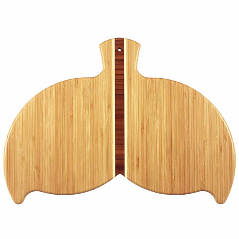 A whale tail-shaped bamboo cutting board from Totally Bamboo, measuring 14-1/2" x 10-1/2", featuring vertical patterns with a darker strip down the center, adds a touch of whimsy to your kitchen wall art collection.