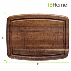 The Totally Bamboo Small Cutting Board with Juice Groove is a rectangular piece crafted from beautiful acacia wood, measuring 8 inches by 6 inches. It features a juice groove around the edge, and the brand name “TB Home®” elegantly adorns the top right corner.