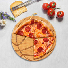 Three slices of pepperoni pizza sit on the Totally Bamboo Basketball Shaped Cutting Board, 12" x 12", alongside a cheese grater, a block of cheese, garlic, and fresh tomatoes on a light gray surface. It's perfect for game day entertaining!