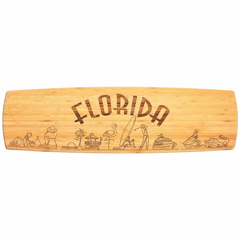 This 30" x 8-1/2" Florida Engraved XL Charcuterie Board by Totally Bamboo showcases "Florida" prominently etched in capital letters, enhanced by intricately illustrated palm trees, a flamingo, a surfer, dolphins, and a sun. This stunning state artwork embodies an inviting tropical and coastal theme that makes it the perfect centerpiece for serving cheese plates.