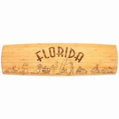 This 30" x 8-1/2" Florida Engraved XL Charcuterie Board by Totally Bamboo showcases "Florida" prominently etched in capital letters, enhanced by intricately illustrated palm trees, a flamingo, a surfer, dolphins, and a sun. This stunning state artwork embodies an inviting tropical and coastal theme that makes it the perfect centerpiece for serving cheese plates.