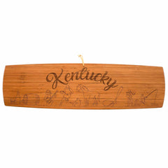 Photo of the Kentucky Extra-Large Charcuterie Board and Cheese Plate, featuring  laser-engraved artwork of the state name and images of fast racehorses, fishing and aged bourbon