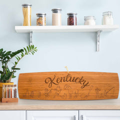 Photo of the Kentucky Extra-Large Charcuterie Board sitting upright on a kitchen counter leaning against the back splash