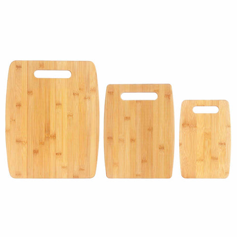 The Totally Bamboo 3-Piece Cutting Board Set includes three wooden boards of different sizes lined up together. Each cutting board features rounded edges and a convenient handle cutout at the top, highlighting the rich wood grain that enhances their natural texture.