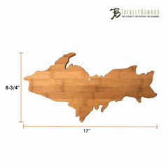 A bamboo charcuterie board shaped like the Michigan Upper Peninsula, measuring 17 inches by 9-1/2 inches. It highlights detailed contours and features the label "Totally Bamboo," perfectly blending function with state pride.