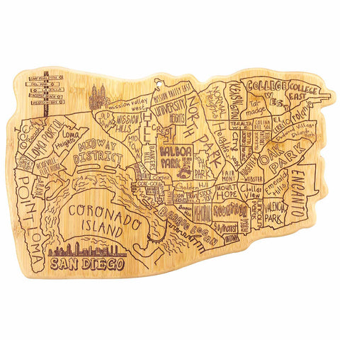 The Totally Bamboo City Life San Diego Cutting Board, measuring 14-1/2" x 9-3/8", is a wooden board intricately shaped like San Diego. It features laser-engraved artwork with neighborhood names such as Coronado Island, Balboa Park, and Gaslamp Quarter, providing a sturdy bamboo surface for your culinary adventures.