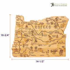 Explore the Destination Oregon Cutting Board by Totally Bamboo. This bamboo board is designed in the shape of Oregon and measures 14-1/2" in width by 10-3/4" in height. It features intricate engravings of landmarks, lakes, and animals such as bears and elk, with the brand logo elegantly placed on the top right corner—a perfect fusion of functionality and artistic design.