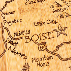 Crafted by Totally Bamboo, the Destination Idaho Cutting Board (15" x 10-1/2") elegantly features a laser-engraved map of Idaho with cities like Boise, Meridian, Caldwell, and Nampa. Major roads such as Highway 84 are detailed on this state-shaped board, with a star marking the location of Boise.