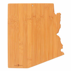 The Totally Bamboo Destination Arizona Cutting Board, measuring 13-1/2" x 11-3/4", is expertly crafted from natural wood with a sleek surface and a convenient small hole for hanging. The beautiful wood grain enhances its functionality and decorative appeal.