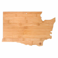 The Destination Washington Cutting Board by Totally Bamboo is a state-shaped board made from bamboo, measuring 15-1/2" x 10". It boasts a smooth cutting surface with light wood tones and includes a small hole for hanging. The board is adorned with laser-engraved artwork, featuring a distinctive logo in the bottom right corner.