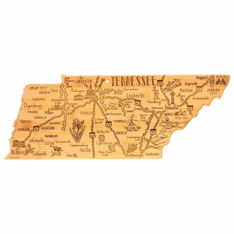 The Destination Tennessee Cutting Board by Totally Bamboo, measuring 18-1/2" x 7", is crafted in the shape of the state and features laser-engraved details of city names, landmarks, and roads. Key locations such as Nashville, Memphis, and Knoxville are prominently highlighted alongside decorative engravings of a guitar and the iconic phrase "Tennessee.