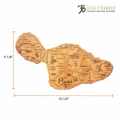 This Destination Maui Cutting Board from Totally Bamboo, shaped like the island of Maui, showcases intricate laser-engraved artwork of its towns and landmarks. It measures 15-1/2 inches wide by 9-1/8 inches tall and features a "Totally Bamboo" logo in the top right corner.