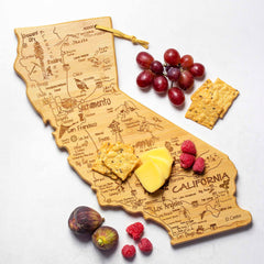 The Destination California Cutting Board by Totally Bamboo beautifully captures the essence of California with a bamboo cutting surface and detailed laser-engraved artwork featuring its cities and landmarks. Perfect for a stunning presentation, it's elegantly adorned with cheese, crackers, grapes, raspberries, and figs.