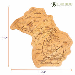 This Totally Bamboo Destination Michigan Cutting Board is crafted from bamboo and designed in the shape of Michigan, featuring engraved map details of cities, lakes, and landmarks. It measures 16-3/4" in height and 16-1/2" in width, with the "Totally Bamboo" brand showcased in the top right corner.