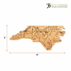 This Destination North Carolina Cutting Board from Totally Bamboo is crafted from bamboo and features a precise laser-engraving of North Carolina's cities and landmarks. Measuring 18 inches wide by 8 inches tall, it prominently displays the "Totally Bamboo" logo in the top right corner.