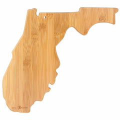 The Totally Bamboo Destination Florida Cutting Board, measuring 13-1/2" x 12-1/4", is a state-shaped cutting board crafted to resemble Florida. It showcases smooth, light brown wood grain with a small hole for hanging. This elegant piece doubles as a bamboo cutting surface and features laser-engraved artwork, making it both functional and decorative.