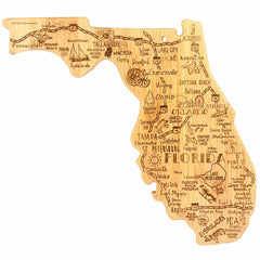 The Destination Florida Cutting Board by Totally Bamboo is a 13-1/2" x 12-1/4" bamboo cutting board shaped like the state of Florida, with laser-engraved designs showcasing city names such as Tampa, Orlando, Miami, and Jacksonville. It also highlights illustrations of local landmarks, wildlife, and popular attractions.