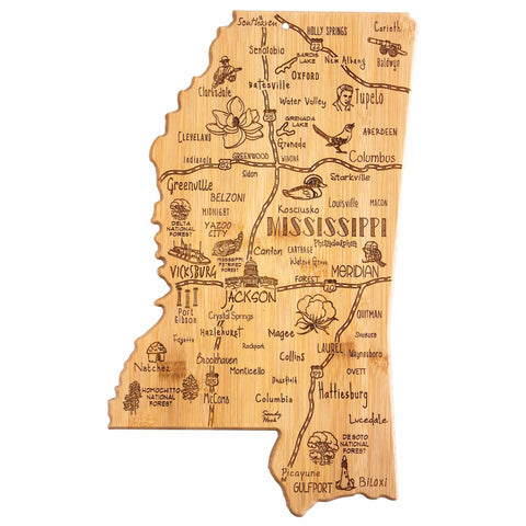 The Totally Bamboo Destination Mississippi Cutting Board, measuring 16-1/2" x 9-3/4", is crafted in the shape of Mississippi with intricate laser-engraved designs depicting cities, landmarks, and symbols such as magnolia flowers, a lighthouse, and cotton. Cities including Jackson, Meridian, and Biloxi are highlighted along with highways and rivers.