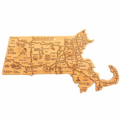 The Totally Bamboo Destination Massachusetts Cutting Board, measuring 16-3/4" x 9-1/4", is shaped like the state and crafted from bamboo. It showcases laser-engraved artwork depicting city names and landmarks such as Boston, Worcester, and Springfield. Decorative symbols and illustrations highlight the essence of the region's unique features.