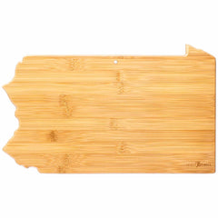 Introducing the Totally Bamboo Destination Pennsylvania Cutting Board, measuring 16" x 9-3/4". This unique wooden cutting board features a smooth bamboo surface shaped like the state of Pennsylvania and includes a convenient small hole near the top for hanging. As part of the Destination Series, it is adorned with laser-engraved artwork that brings charm to any kitchen.