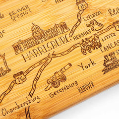 Close-up view of engraved artwork on Pennsylvania state shaped bamboo serving board