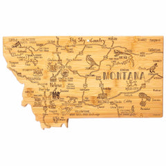 Totally Bamboo presents the Destination Montana Cutting Board, measuring 16" x 9-1/2", featuring a laser-engraved illustrated map of Montana that showcases major cities, national parks, and landmarks, including Glacier National Park and Yellowstone National Park. Adorned with sketches of animals, trees, and notable sites, this board includes labels highlighting towns and attractions.