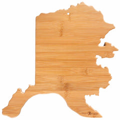 The Totally Bamboo Destination Alaska Cutting Board, measuring 13-3/8" x 13-1/2", is crafted from smooth, natural wood grain and outlines the state of Alaska, featuring a small hole at the top for easy hanging. This distinctive piece adds charm to any kitchen.