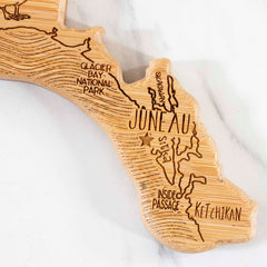 The Destination Alaska Cutting Board by Totally Bamboo beautifully features a laser-engraved wooden map of Alaska, accentuating Glacier Bay National Park, Juneau, and Ketchikan. Its intricate design also incorporates the Inside Passage and surrounding geography, providing a unique perspective on this majestic region. This cutting board measures 13-3/8" x 13-1/2".