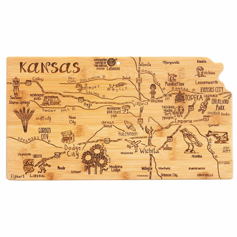 The Totally Bamboo Destination Kansas Cutting Board, measuring 16-3/4" x 9-1/4", features a unique design showcasing the state's shape with laser-engraved city names and icons such as cowboy boots and wheat. Major cities like Wichita, Topeka, and Kansas City are marked along with roads and rivers for a distinctive state-themed cutting board experience.