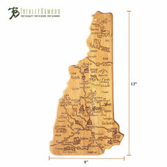 This Destination New Hampshire Cutting Board, measuring 9 inches by 17 inches, is crafted from quality bamboo and replicates the state of New Hampshire. It features intricate laser-engraved artwork of local landmarks and city names, serving as both a functional bamboo cutting surface and a decorative piece. The Totally Bamboo logo is displayed at the top.