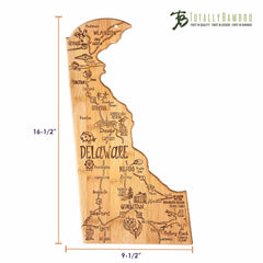 The Totally Bamboo Destination Delaware Cutting Board is a bamboo surface shaped like the state of Delaware, adorned with laser-engraved artwork showcasing city names and landmarks such as Wilmington, Dover, and Rehoboth Beach. It measures 16-1/2" tall by 9-1/2" wide.