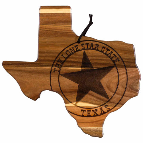 Introducing the Rock & Branch® Origins Series Texas Cutting Board by Totally Bamboo: a beautifully crafted cutting board shaped like Texas, made from rich acacia wood. It features a laser-engraved black star and the text "The Lone Star State Texas." A convenient black cord is attached to the top for easy hanging.