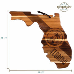 The Rock & Branch® Origins Series Florida Cutting Board by Totally Bamboo is a delightful homage to the state, crafted from Acacia wood. It showcases laser-engraved artwork of palm trees and the word "Florida," measuring 12-1/4 inches by 13-1/2 inches, and comes with a brown leather loop for convenient hanging.