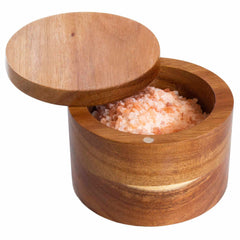 The Rock & Branch® Salt Cellar by Totally Bamboo is a handcrafted Acacia container with a sliding lid, partially open to show Himalayan pink salt crystals inside. A discreet magnetic lock keeps the 6-oz. capacity contents secure and fresh.