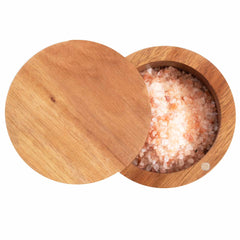 Introducing the Rock & Branch® Salt Cellar by Totally Bamboo, featuring a 6-ounce capacity and a magnetic lock lid that slightly opens to reveal coarse pink Himalayan salt. The irregularly shaped crystals exhibit varying shades of pink and white. Both the container and its lid possess a smooth finish, bringing an elegant touch to your kitchen counter.