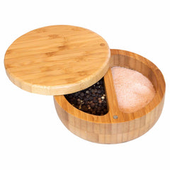 The Totally Bamboo Salt Keeper Duet Salt Cellar, with its sleek round design and natural wood finish, features a swivel lid with a magnetic lock. When partially opened, it reveals two compartments—one for storing black peppercorns and the other for pink Himalayan salt.