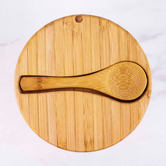 The Big Dipper Salt Cellar with Salt Spoon by Totally Bamboo, featuring a 10-ounce capacity, is displayed against a light marbled background. The bamboo spoon fits perfectly into an indentation on the lid, offering a seamless and natural design.